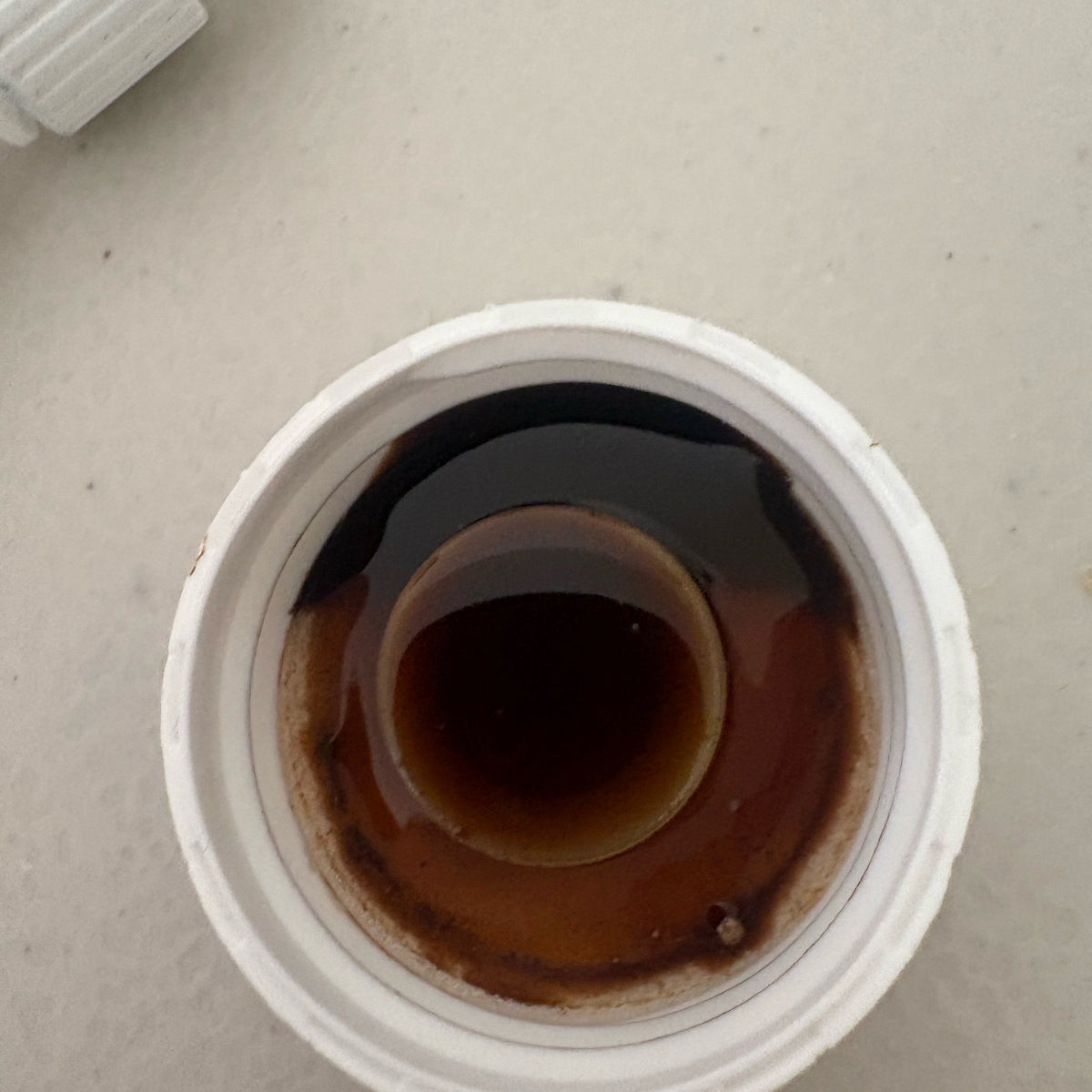 Close-up of BloomGrow concentrate in the bottle cap